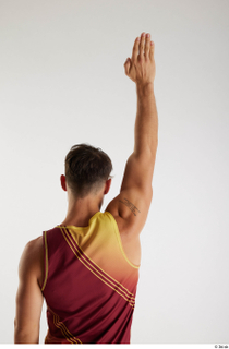 Darren  1 arm back view dressed flexing red-yellow tank…